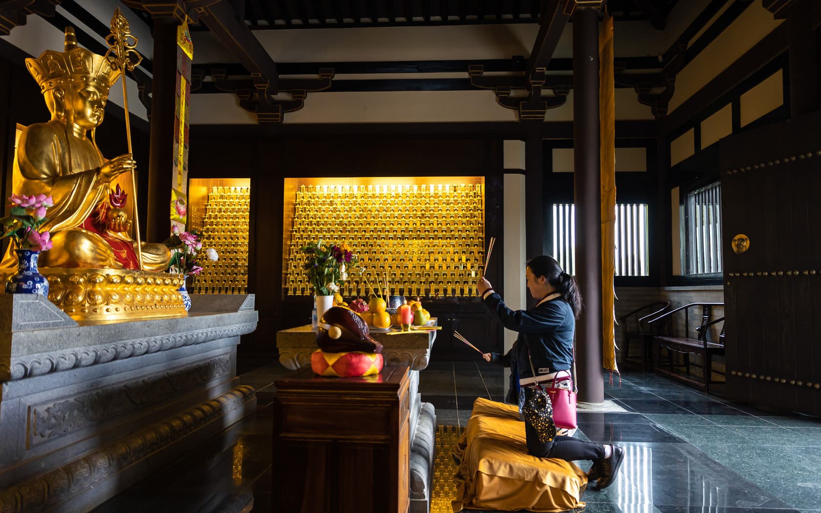Mother and child pray at temple in Springvale Botanical Cemetery