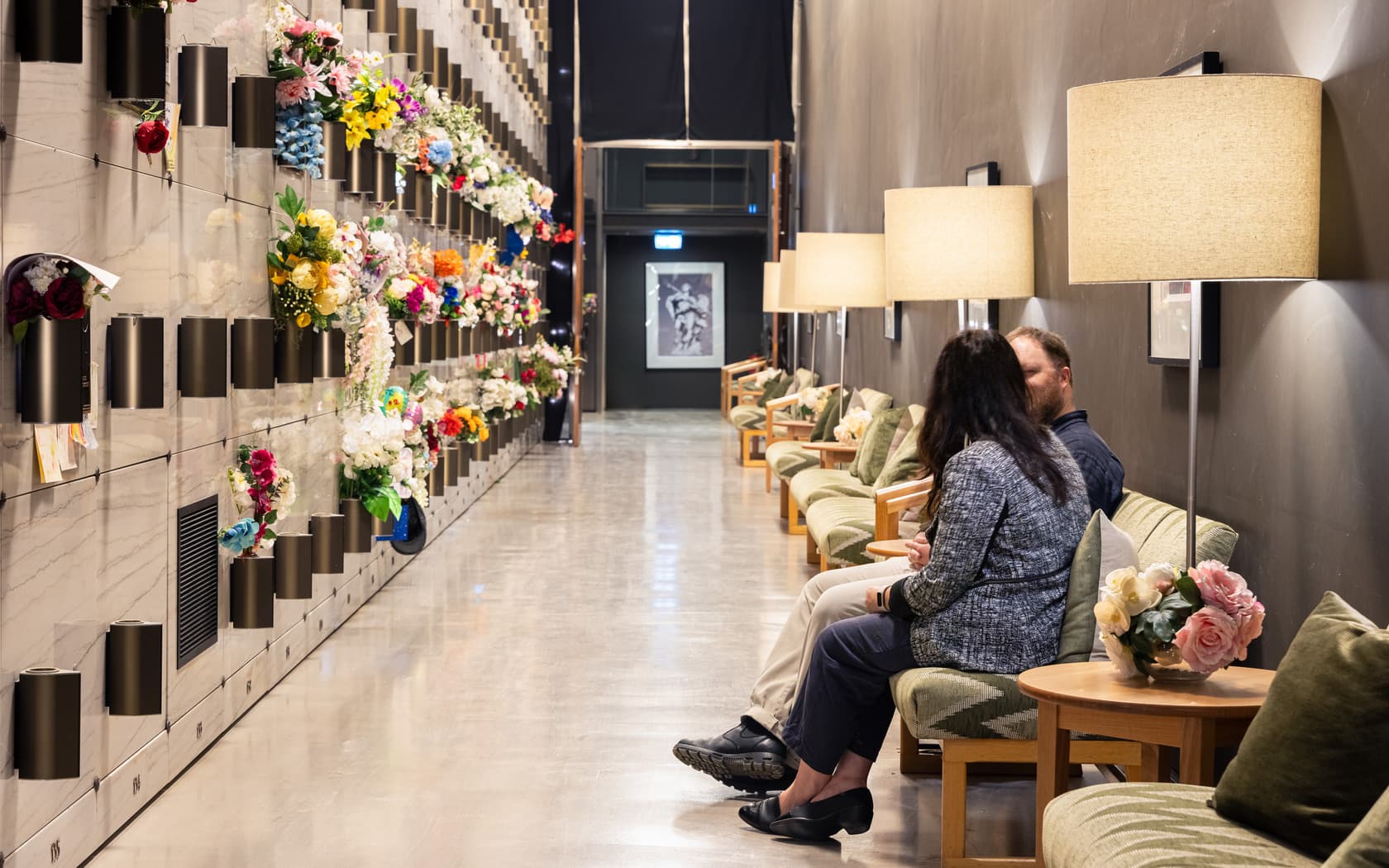 Two people seated and reflecting inside a peaceful mausoleum in Melbourne